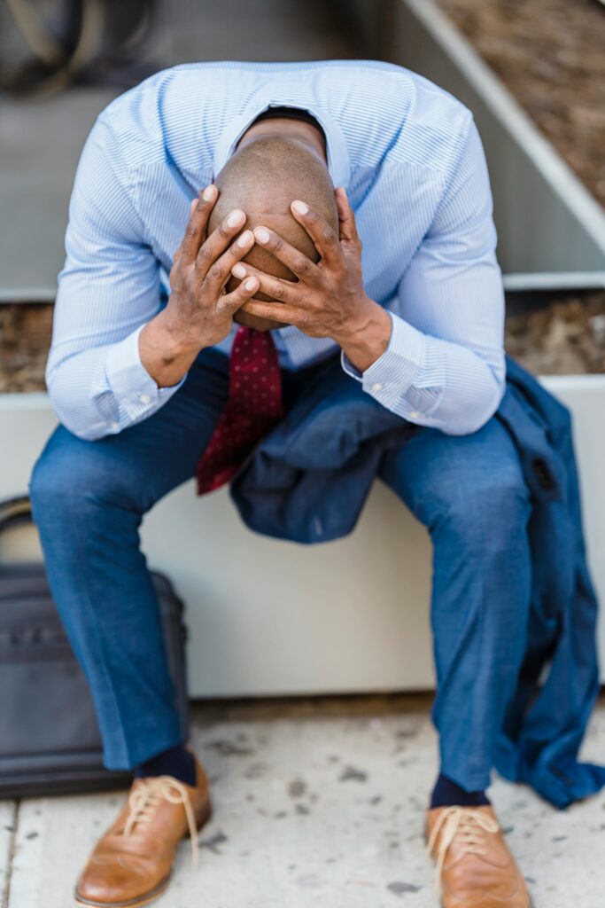 a man holding his bowed head