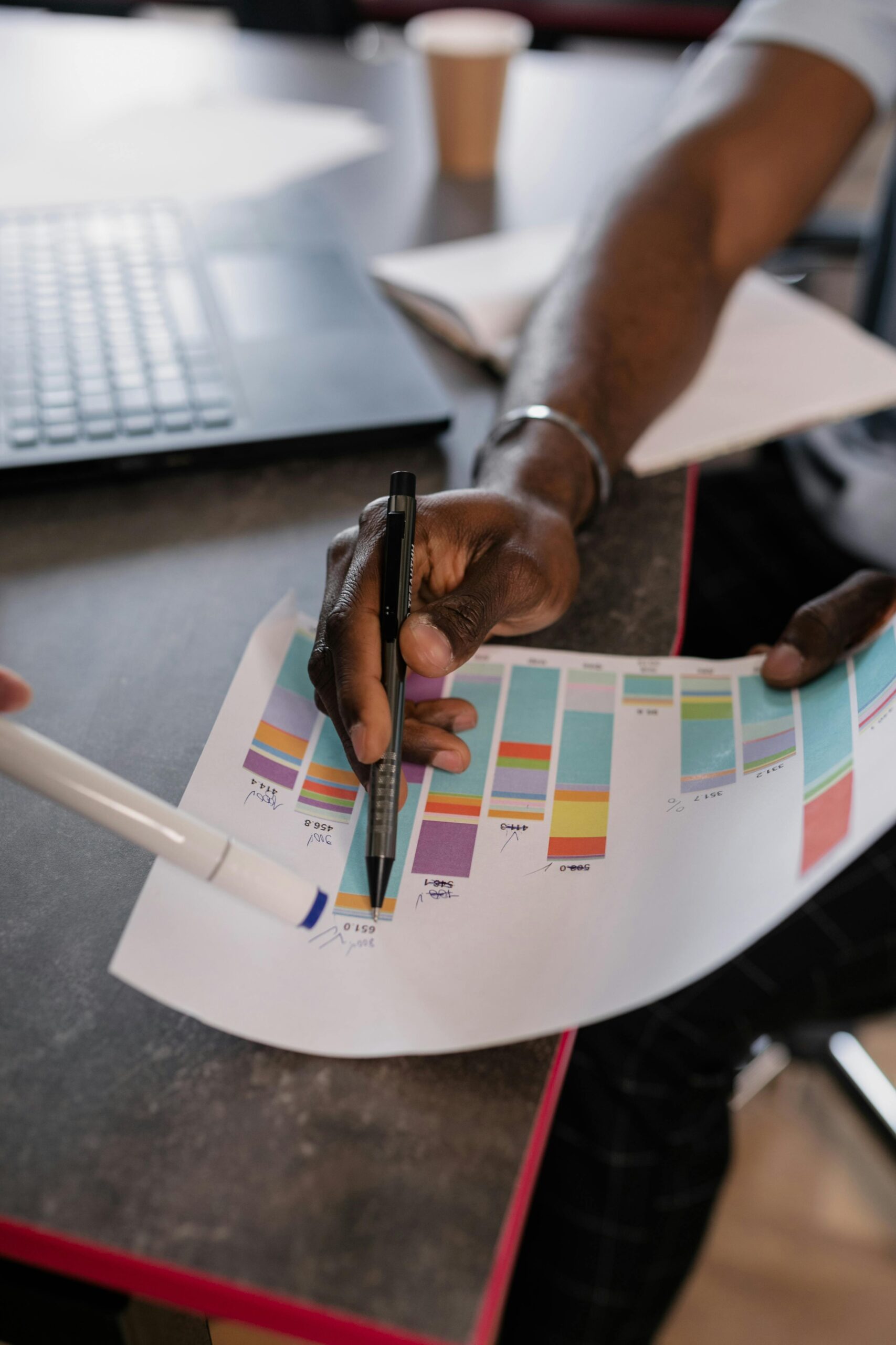 someone analyzing charts on a sheet of paper