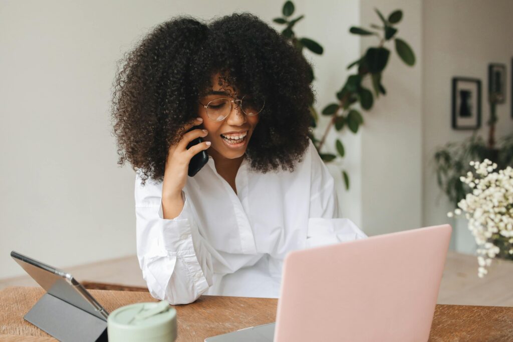 Woman in White Long Sleeve Shirt Using Her Smartphone